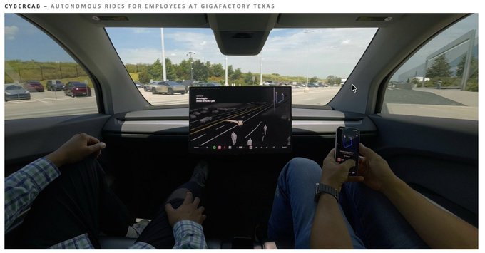 Two passengers sit hands-free inside a Tesla Cybercab at GigaFactory Texas, with one person checking their phone while the vehicle's central touchscreen displays its autonomous driving interface navigating the surroundings.

This image visually supports the post's message about Tesla's broader ecosystem beyond just electric cars—specifically highlighting the company's progress in **autonomous driving and Robotaxi technology**, as the Cybercab is designed to operate without a driver, embodying Tesla's AI-driven mobility vision.