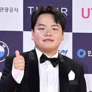 The image shows a man dressed formally, wearing a black suit with white polka dots and a bow tie, standing against a backdrop of a table displaying logos such as "Tiger" and "UBC". The man is giving a thumbs-up gesture, indicating approval or positivity. The accompanying post discusses an incident involving an employee whose laptop was compromised, possibly due to insufficient security measures, leading to the loss of $36M. Additionally, it mentions that some individuals are now seeking solutions related to identity and trust issues in the aftermath of this incident.