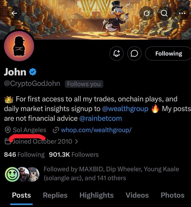 Twitter profile of "John" (@CryptoGodJohn), a verified account with 901.3K followers, whose bio features a crown emoji and promotes access to trades via @wealthgroup with location listed as "Sol Angeles" (highlighted in red), directly tying into the post's playful reference to that location.