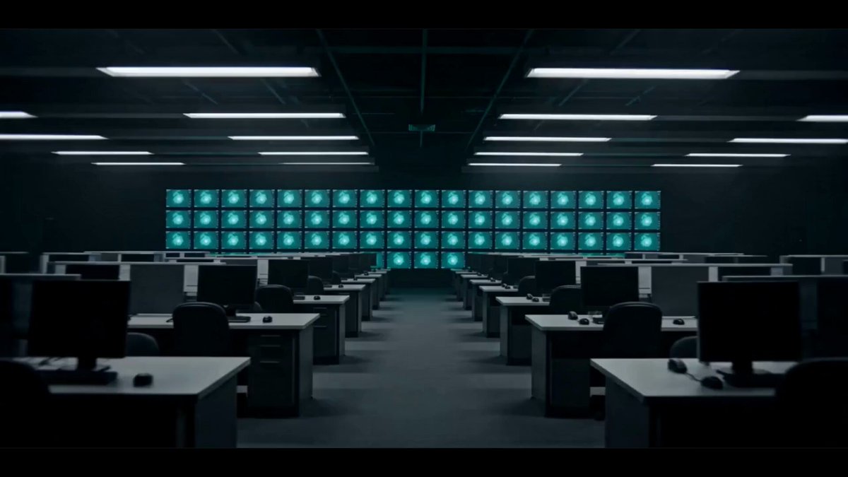 The image shows an office space with multiple desks and computers arranged throughout the room. The walls are covered in screens displaying weather forecasts for various cities around the world. These forecasts indicate that there might be a storm approaching, which could potentially impact travel plans or business operations. The presence of AI agents suggests that this information is being used to predict market trends and make financial decisions based on the weather conditions.