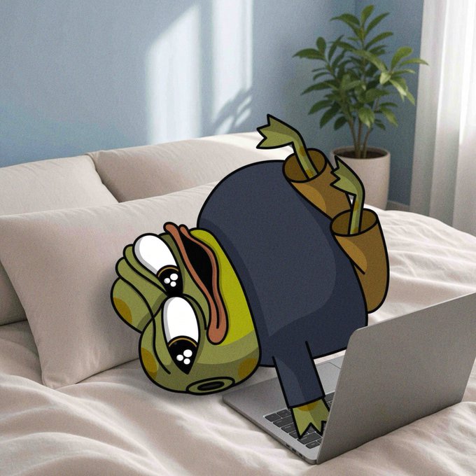 A photoshopped meme image of a cartoon frog character in business attire appearing to fall onto a MacBook laptop on a bed.