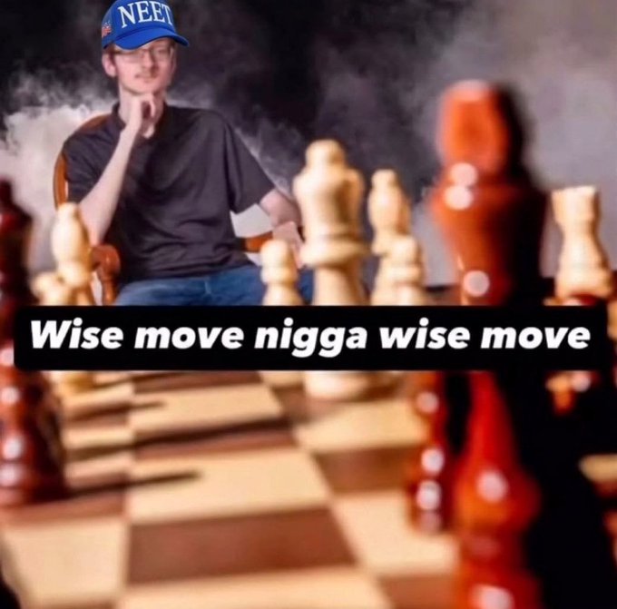 The image features a man sitting at a wooden chessboard, wearing a blue baseball cap with "neet" written across it. The man appears to be deep in thought as he contemplates his next move. In the background of the image, there are several pieces of wood that make up the chess set, and the text "wise move Nigga wise move" is visible on the board. This suggests that the man might be a fan of the game or an enthusiast who enjoys playing it. The post also mentions that the man will likely be tweeting about his experience with the game, possibly including some interesting moves he has made or discussing chess strategies in general.