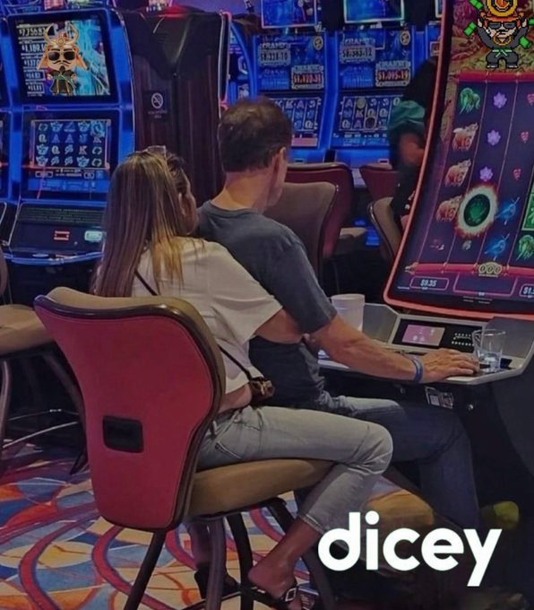 A man and woman sitting close together playing slot machines in a casino, with the 'dicey' logo visible at the bottom.