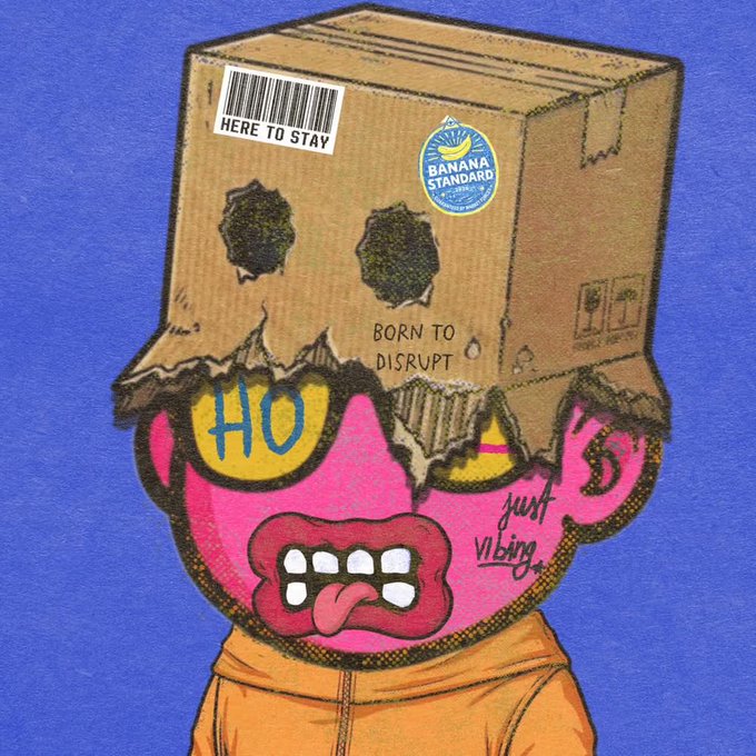 Illustration of a pink cartoon character wearing a cardboard box on its head, featuring a "Banana Standard" sticker, a "HERE TO STAY" barcode label, and the text "BORN TO DISRUPT" and "just vibing" on its body.
