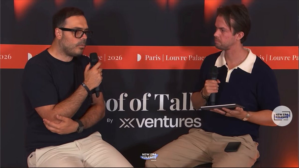 The image features two men sitting next to each other, both holding microphones as they engage in a conversation. They are positioned against a backdrop of a red banner that reads "FOOT OF TALL" and "XVENTURES". The men appear to be discussing something related to stablecoins or cryptocurrency transfers, which is the main focus of the image.