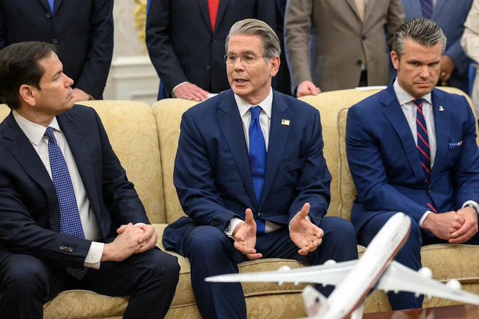 Treasury Secretary Scott Bessent (center) sits in the Oval Office alongside Secretary of State Marco Rubio (left) and Secretary of Defense Pete Hegseth (right), likely during a cabinet meeting or policy discussion. The image connects to the post's theme of macro policy and Treasury bond market intervention, illustrating the administration's key decision-makers as Bessent oversees the expanded long-term bond buyback program aimed at pressuring yields downward.