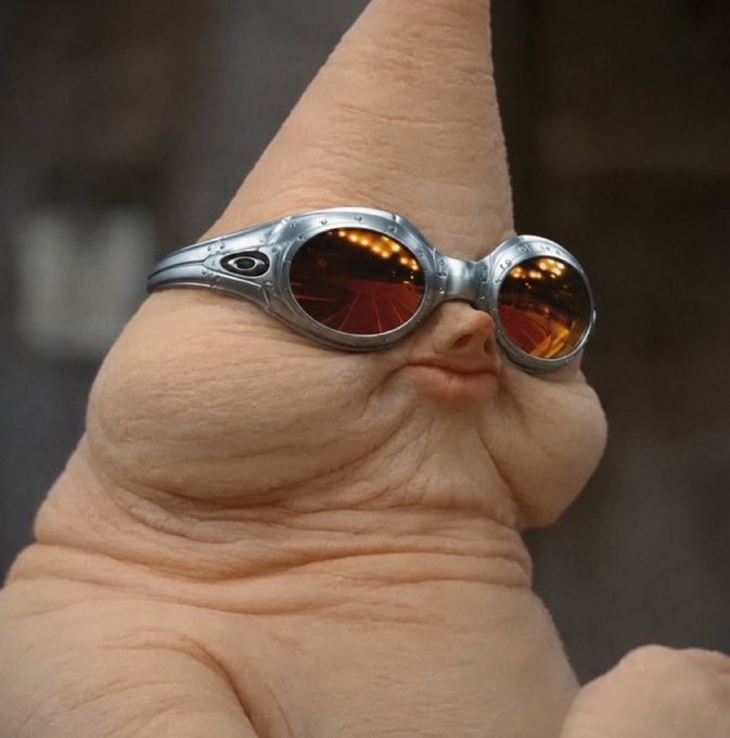 The image shows a close-up of a pale, wrinkled creature resembling a hairless mole rat wearing steampunk-style silver goggles with orange-tinted lenses. The accompanying post humorously suggests crypto investors will end up looking this weathered and wealthy, wearing their luxury eyewear after making 16 million on the blockchain.