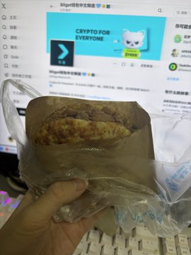 The image shows a person holding a sandwich wrapped in plastic, which appears to be a BLT (bacon, lettuce, and tomato) sandwich. The person's hand is positioned over a computer keyboard, suggesting that they are working or using their computer while enjoying their meal. The background of the image features a monitor displaying a website called "crypto for everyone". This indicates that the person might have been browsing the internet during their lunch break or taking a break from work to enjoy some food and stay connected with others through social media platforms.

The post also mentions Bitcoin, which is a digital currency that has gained popularity in recent years. The image could be related to Bitcoin or cryptocurrency discussions, as it shows someone using their computer while eating a BLT sandwich.