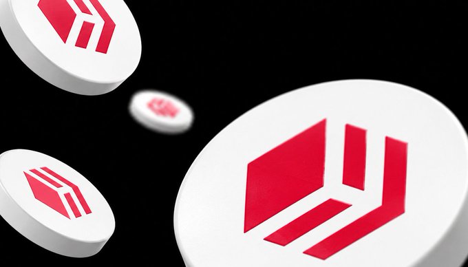 3D rendered white discs with red geometric logos (appears to be a cryptocurrency token) floating against a black background.