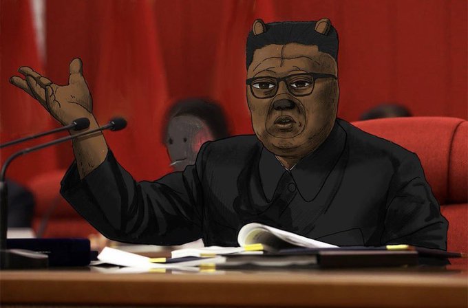 A stylized digital illustration showing Kim Jong-un's face edited with bear ears, sitting at a desk with microphones in a red chair, appearing to make a speech or gesture.