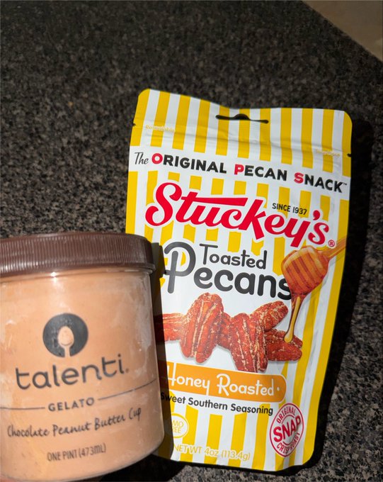 A photo showing a pint of Talenti Gelato (Chocolate Peanut Butter Cup flavor, 473mL) next to a yellow-striped bag of Strikey's Toasted Pecans (Honey Roasted, Southern Seasoning, 4.7 oz / 113.4g), both sitting on a dark granite countertop.