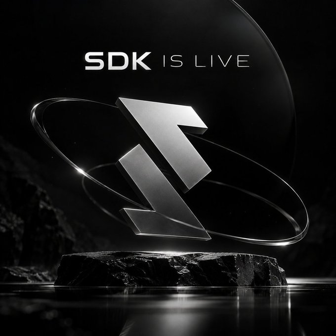 A dramatic 3D-rendered graphic with the text 'SDK IS LIVE' above a metallic, angular logo orbiting a dark sphere against a black background.