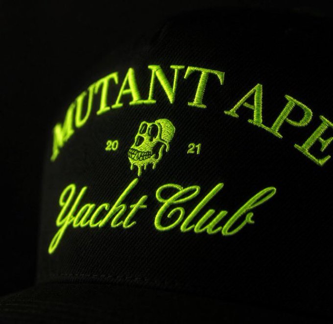 A black snapback hat features neon green embroidered text reading "MUTANT APE" arched across the front, with "Yacht Club" in cursive script below, flanking a skull graphic dripping with green slime and the numbers "20" and "21," representing the Bored Ape Yacht Club's Mutant Ape collection referenced in the owner's post about being scammed out of two Mutant Apes on Discord and struggling to rebuild.