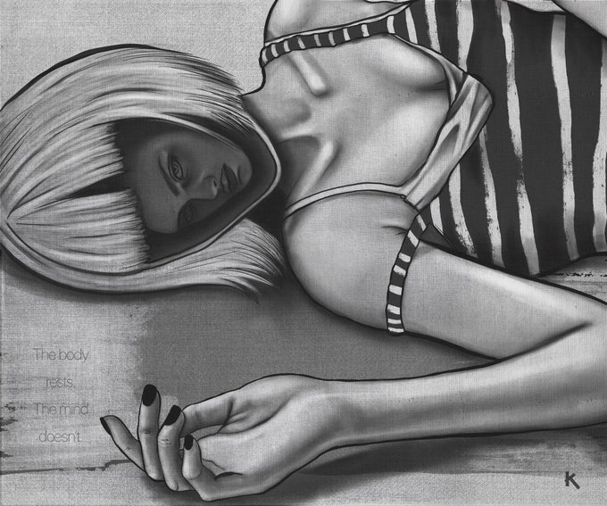 The woman's pose, with her head resting on her arm and her hand raised, creates a sense of tranquility and stillness. The black and white color scheme adds an artistic touch to the image.