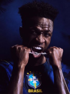 Dramatic portrait of a Brazil national football team player (CBF jersey) baring his mouthguard in a menacing pose.