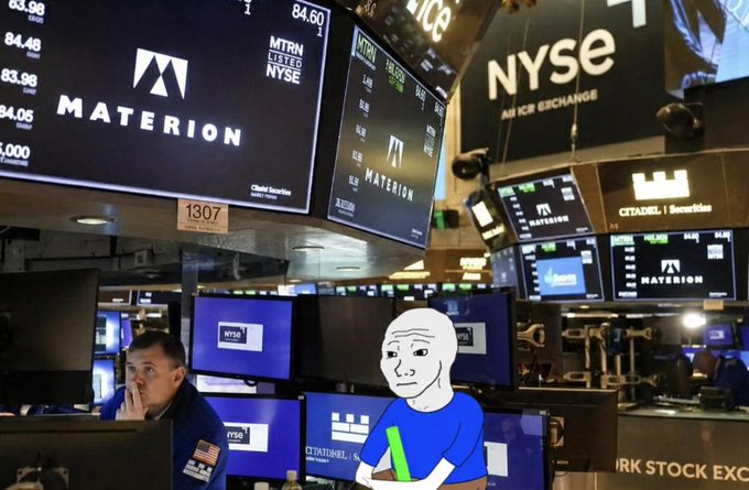 A trader works the floor of the NYSE under digital ticker displays showing "MATERION" at $84.60 with "MTRN LISTED NYSE," perfectly capturing the bullish excitement of the trader meme who is unusually erect for a September market session.