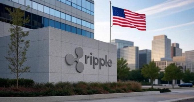 The image shows the exterior of a modern corporate building featuring the "ripple" logo prominently displayed on a stone wall, with an American flag waving above and a city skyline in the background. This imagery directly supports the post's bullish announcement about Ripple gaining National Trust Bank status in the U.S., visually reinforcing the company's growing American institutional presence and legitimacy in the traditional banking sector.