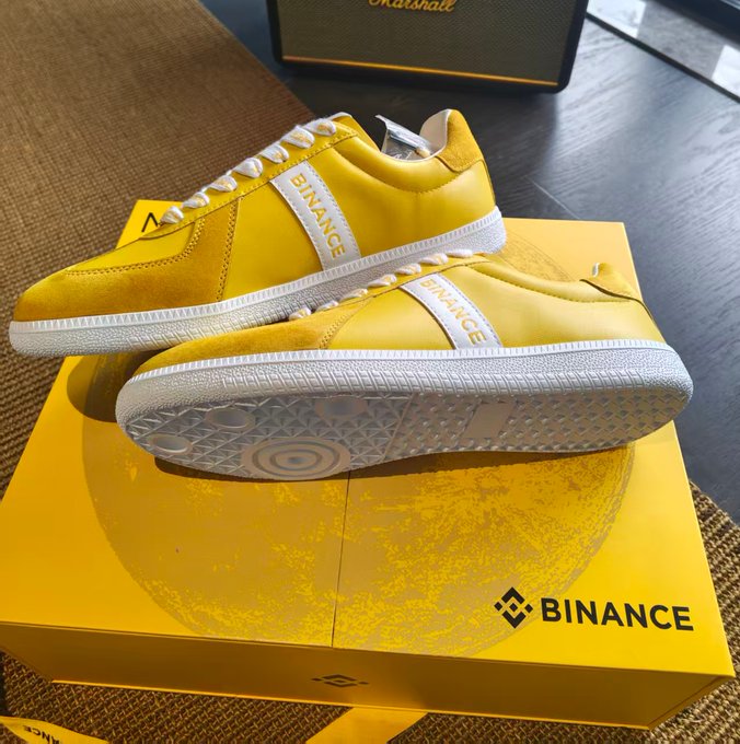 A pair of bright yellow Binance-branded sneakers rests on a matching yellow Binance box, gifted by @binancezh in celebration of the Mid-Autumn Festival as a stylish token of appreciation to the crypto community.