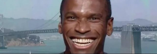 The image shows a man with a big smile, looking directly at the camera. In the background, there is a bridge that stretches across the scene. The caption of the image reads "WLD just exploded +33% after Arthur Hayes started hyping Worldcoin again. One tweet from a big crypto name is still enough to send low-cap AI narratives into full degen mode while traders rush to chase momentum". This suggests that there might be an upcoming event or trend related to cryptocurrency that has caught the attention of many people, causing the sudden explosion in popularity for Worldcoin and potentially other cryptocurrencies.
