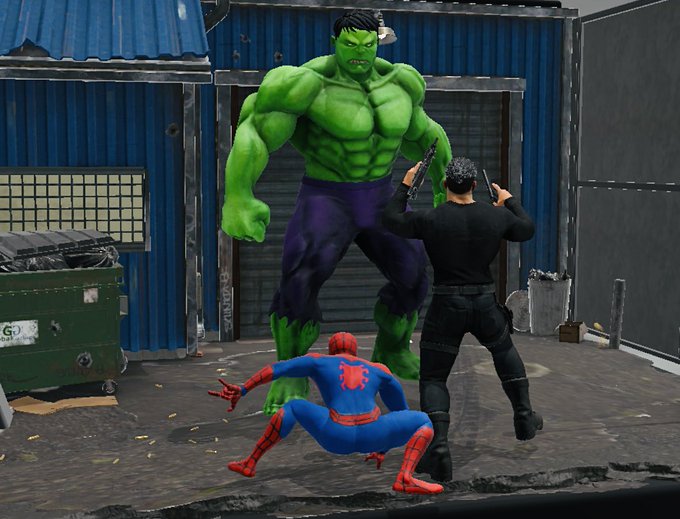A video game scene showing Spider-Man crouching in a defensive pose while facing off against the Hulk, with another armed character standing nearby in an industrial setting.