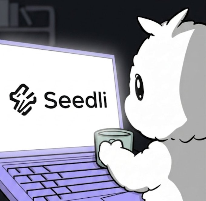 An illustrated cartoon shows a white bird-like character holding a small cup while looking at a laptop screen that displays a logo and the text 'Seedli'.