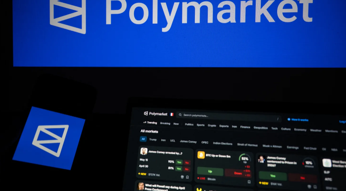 The image shows the Polymarket logo and website displayed on screens, with the site's homepage visible showing various prediction markets including politics, sports, crypto, and trending categories like James Comey and Disney Stock. This relates to the post's claim that Polymarket is raising at a $20 billion valuation, alongside rival Kalshi's $40 billion valuation, totaling $60 billion for the prediction market sector.