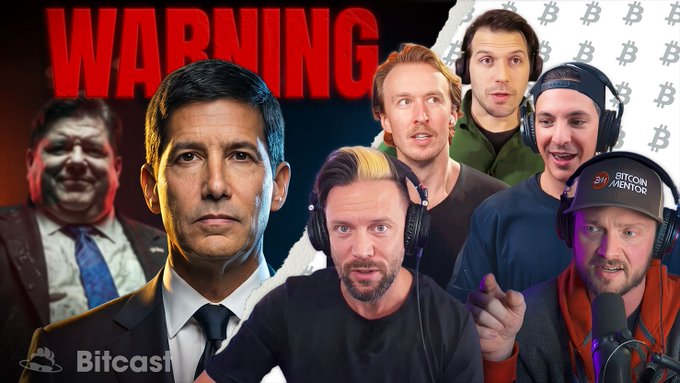 The image features a poster with a group of men wearing headphones, all posing for a photo. The poster also includes text that reads "WARNING" and "THE Fed Used Bitcoin To Distract You". This suggests that there might be an event or situation related to Bitcoin or cryptocurrency in progress, possibly involving the use of Bitcoin as a tool for distraction.