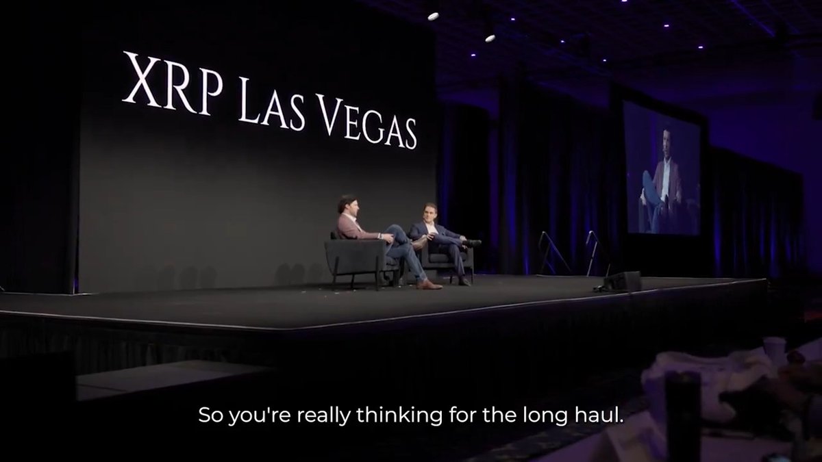 XPPR Las Vegas event stage with two individuals seated, accompanied by a large screen displaying the XPPR Las Vegas logo and text.