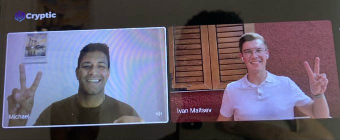 A video call screenshot featuring two young men—labeled 'Michael' and 'Ivan Maltsev'—both smiling and making peace signs on a 'Cryptic' video platform.