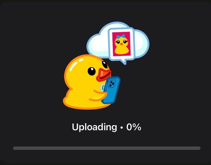 A digital illustration features a yellow cartoon duck holding a blue smartphone, with a thought bubble containing its own photo, above the text 'Uploading · 0%' and a progress bar on a dark background.