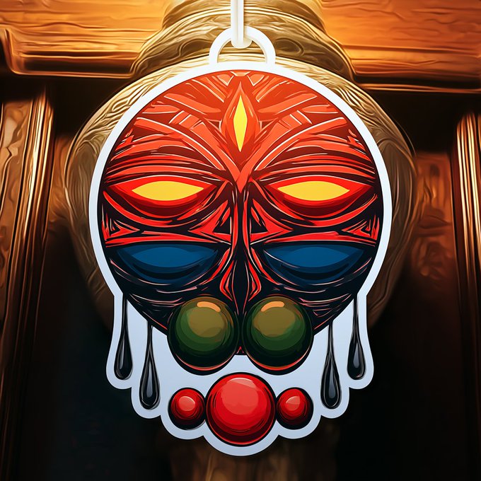 A vibrant digital artwork titled "Ember Totem" features a stylized tribal mask with glowing orange-red eyes, a blue face, green orbs, and a red gem pendant, dripping with black tears. The bold, fiery design reflects the totem's theme of being "forged in fire, remembered in eternity," and is presented as a 4-edition NFT on the Tezos blockchain (objkt.com).
