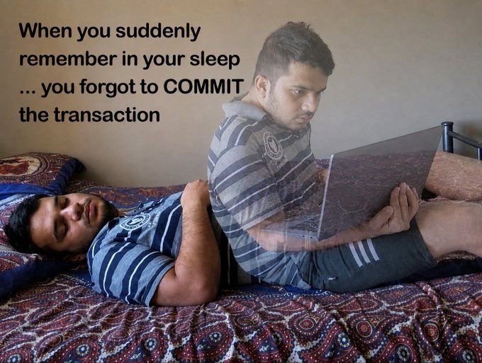 A meme showing two identical-looking men on a bed, one sleeping and the other wide awake working on a laptop, with text reading: 'When you suddenly remember in your sleep ... you forgot to COMMIT the transaction'.