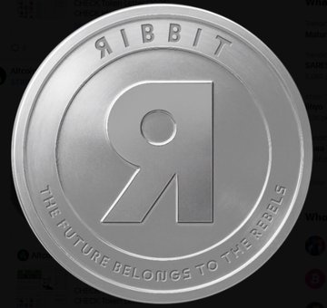 A metallic silver coin featuring a large 'R' logo with the text 'RIBBIT' on top and 'THE FUTURE BELONGS TO THE REBELS' along the bottom edge.