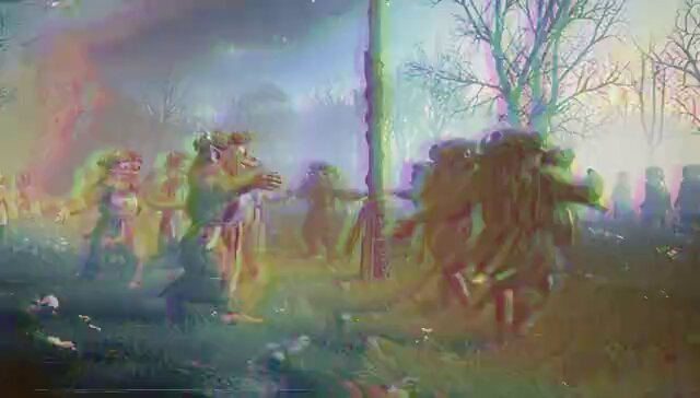 The image features a group of people dressed up, possibly attending a themed party or event. They are standing around a pole with a banner that says "Midsommar" written on it. The background includes trees and bushes, giving the scene an outdoor setting. The colors in the photo appear to be somewhat faded, which adds a vintage feel to the image.