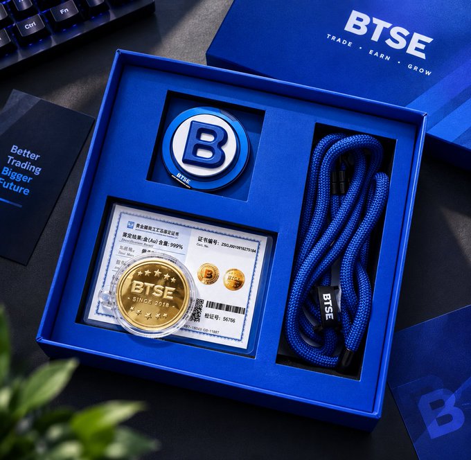 Product photo of a BTSE branded gift box in blue containing a BTSE 'B' token/coin, a commemorative BTSE 'SINCE 2018' gold coin in a protective case with an authentication card, a blue braided USB cable, and a BTSE branded notebook.