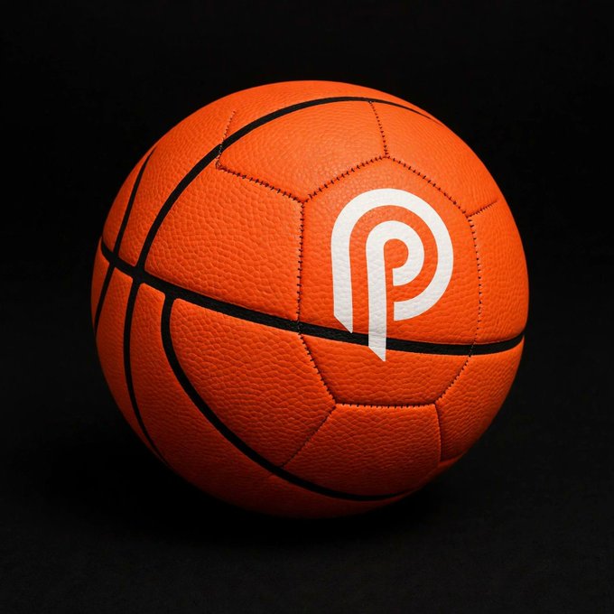 An orange basketball with black seams featuring a white stylized 'P' logo displayed against a black background.