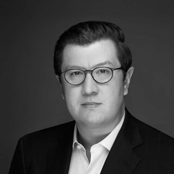 A black-and-white professional headshot shows a man with glasses, wearing a suit jacket and white shirt, against a gray background. The image relates to the post about Tyler Williams, Bessent's top crypto advisor at the Treasury, reportedly departing after 17 months with no named successor.