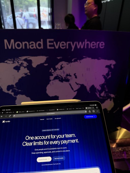 A laptop screen displays the Ramp website with the text 'One account for your team. Clear limits for every payment,' positioned in front of a banner reading 'Monad Everywhere' with a world map.