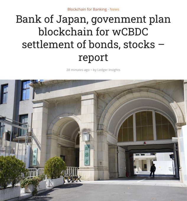 A news article from Ledger Insights headlined 'Bank of Japan, government plan blockchain for wCBDC settlement of bonds, stocks – report,' published 28 minutes ago, with a photograph of the Bank of Japan's stone arched entrance.