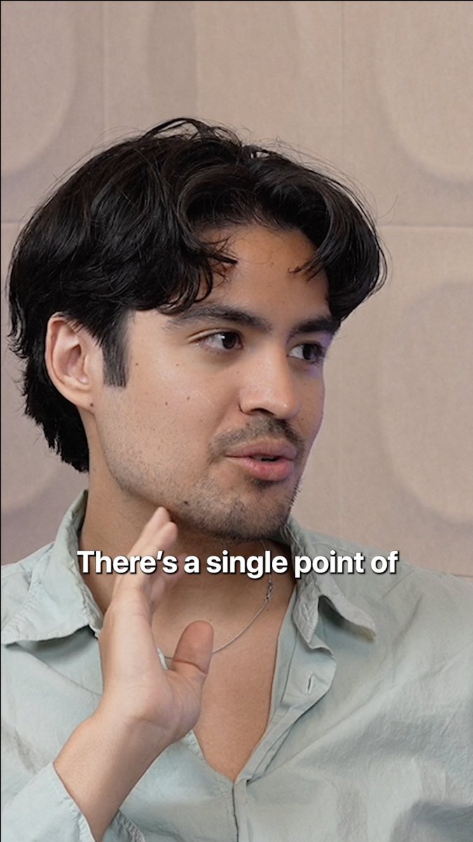 A man with dark wavy hair and a light green shirt gestures while speaking, with the on-screen text "There's a single point of" suggesting he's mid-discussion, likely about the guardrails needed as AI integrates into workflows—aligning with the post's theme of AI oversight featuring Jack Cameron of Insomnia Labs and @aptAlix of Aptos Foundation.
