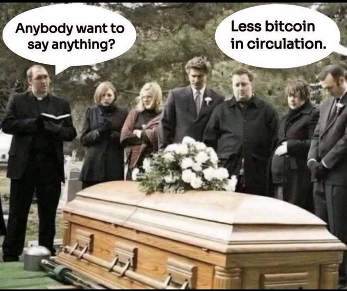A group of mourners stands solemnly around a closed wooden casket adorned with white flowers at a graveside service. A priest asks, "Anybody want to say anything?" while another person responds with a joke: "Less bitcoin in circulation."