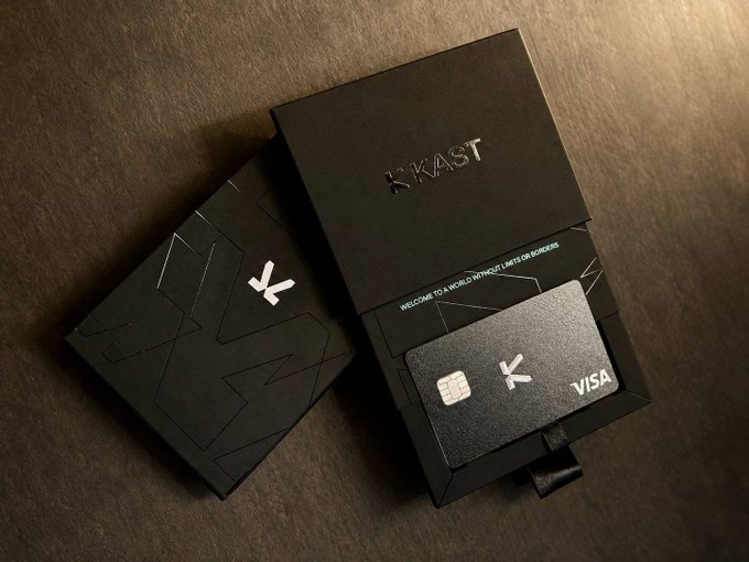 Black packaging and a Visa credit card for 'KAST' are displayed on a dark surface, with text reading 'WELCOME TO A WORLD WITHOUT LIMITS OR BORDERS'.