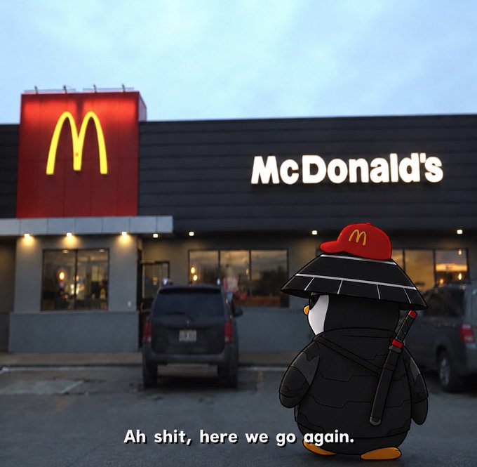 A cartoon penguin dressed in a ninja-like black outfit and a red McDonald's hat stands in a McDonald's parking lot, with the text "Ah shit, here we go again." displayed at the bottom. The image humorously captures the penguin's resigned reaction to yet another visit to McDonald's, matching the post's "Gmmmmmmmmmmmmmm" with a relatable craving for their familiar menu.