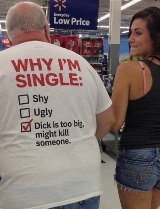 An older man in a Walmart wears a t-shirt reading "WHY I'M SINGLE:" with checkboxes for "Shy", "Ugly", and a checked box for "Dick is too big, might kill someone," while a young woman in a tank top stands nearby.