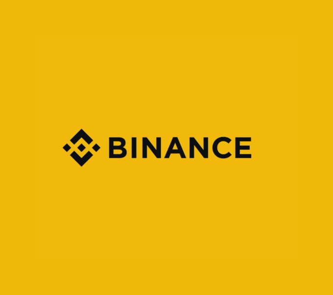 The image features the Binance logo in black on a bright yellow background. This visual pairs with news of the cryptocurrency exchange's plans to relaunch in the UK by 2027, following a regulatory-driven pause on local user onboarding in 2023.
