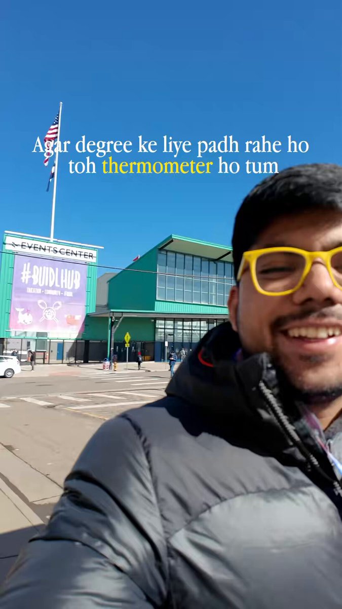 The image features a man wearing yellow glasses, smiling for the camera while standing outside of a building with a green roof. There are several other people visible in the background, but they are not the main focus of the photo. The caption "I miss @EthereumDenver" is written above and below the man's head, suggesting that he might be interested in or following the Ethereum blockchain project.