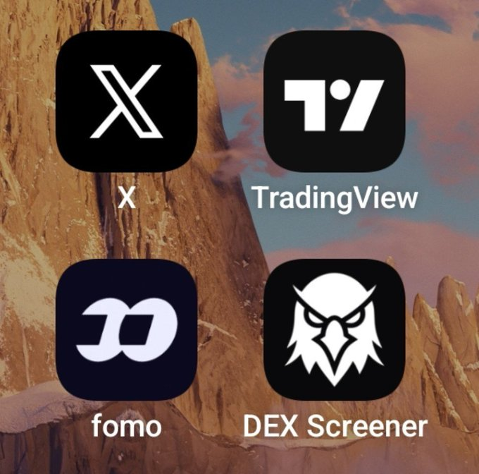 A smartphone home screen displaying four app icons—X, TradingView, fomo, and DEX Screener—set against a background image of a rocky mountain.