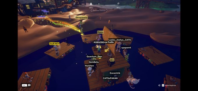 In-game screenshot of a multiplayer blockchain game showing player avatars with usernames like Dinopawz, Lucky__motya__CATS, Quantum_Gun, Excentrik, and CATSofPAXAN gathered on wooden docks in a sandy environment.