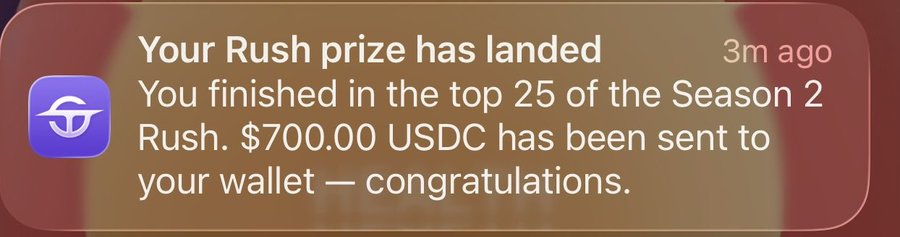 A notification screenshot reading 'Your Rush prize has landed: You finished in the top 25 of the Season 2 Rush. $700.00 USDC has been sent to your wallet — congratulations.'