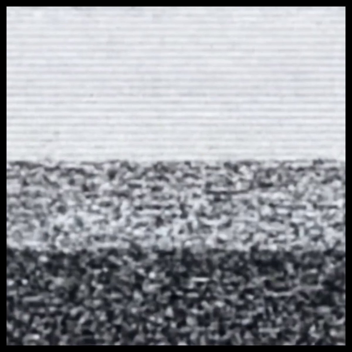 The image shows a close-up view of an abstract painting featuring black and white textures with small details. The colors appear to be a mix of black, white, and gray. The painting is displayed within a frame containing text that provides information about the content or context related to it but does not provide any additional details about the painting itself.